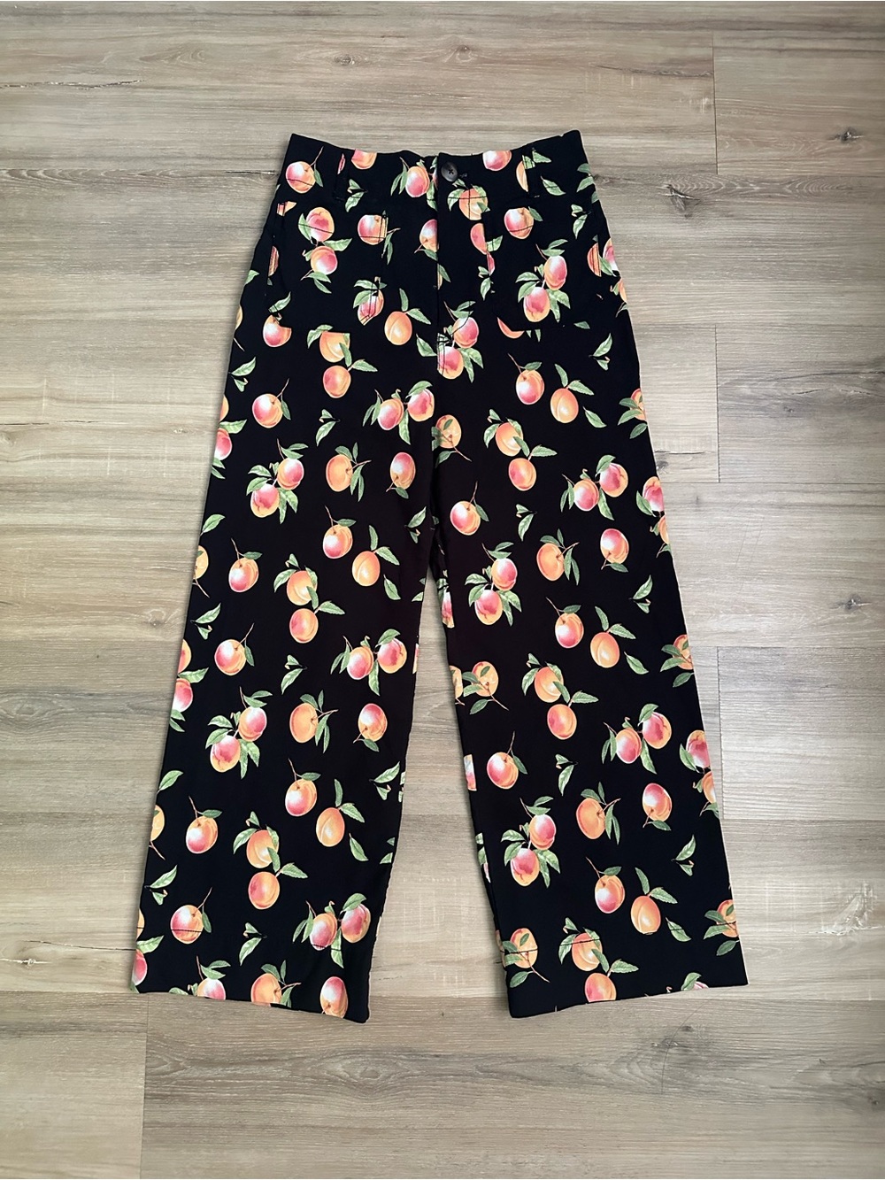 Maeve by Anthropologie Colette pants featuring a colorful peach/fruit print.